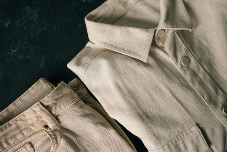 Men wearing khaki shorts and a lightweight chore jacket for summer style.